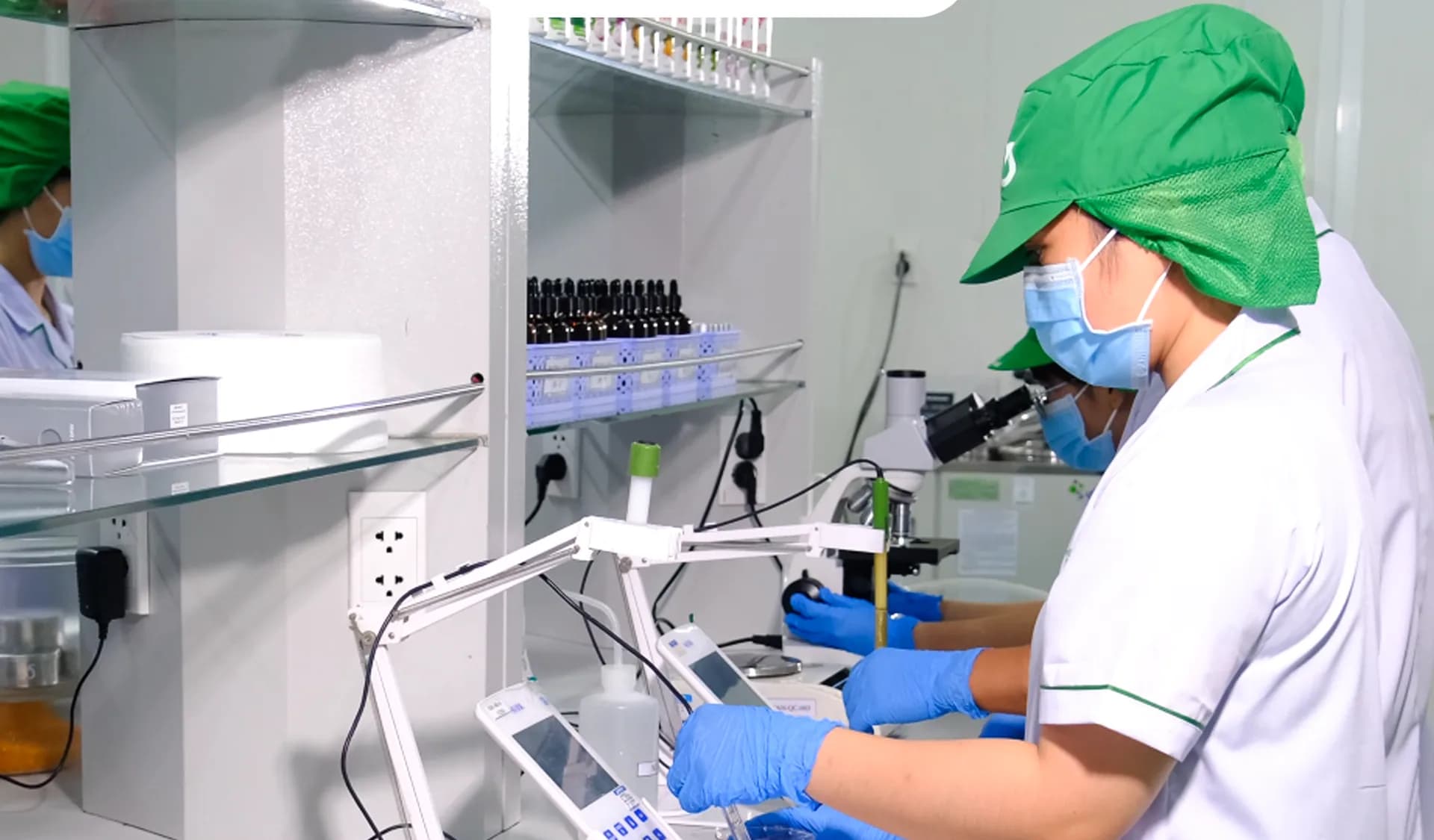 Laboratory staff working with samples and bench instruments.